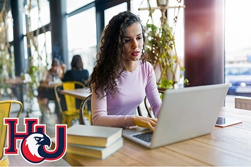 Woman on a computer working on Hodges Direct course