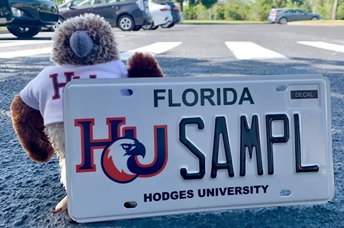 Keaton holding a Hodges License Plate.